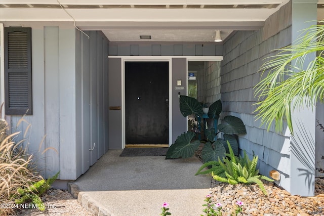 view of exterior entry featuring board and batten siding