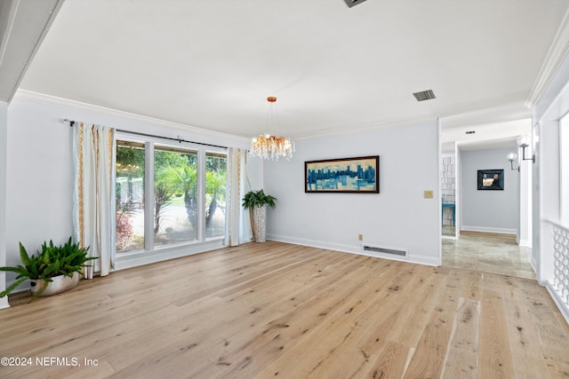 unfurnished room featuring crown molding, baseboards, visible vents, and light wood-style floors