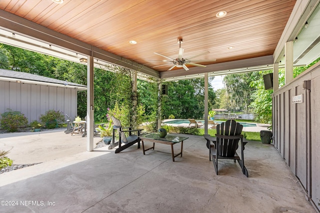 view of patio with a ceiling fan and an outdoor pool