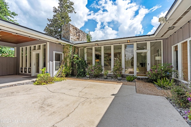 view of patio featuring a sunroom