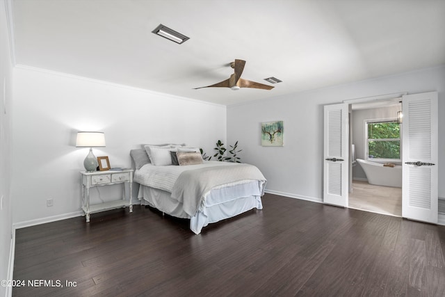 bedroom with visible vents, baseboards, and wood finished floors