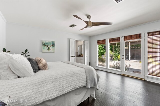 bedroom featuring multiple windows, dark hardwood / wood-style floors, and access to exterior