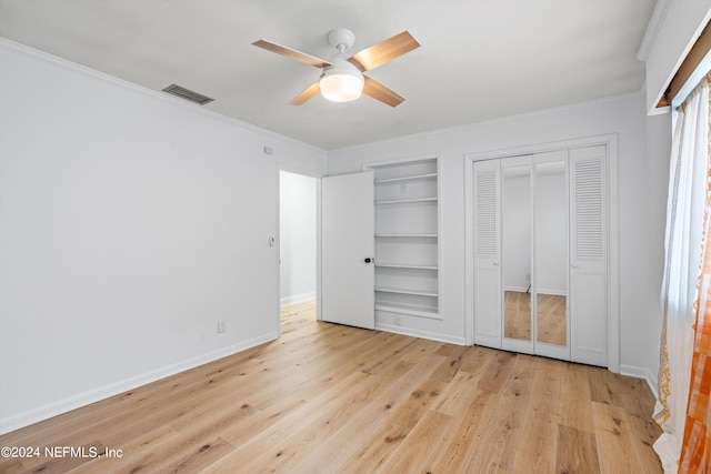 unfurnished bedroom with light wood-type flooring, ornamental molding, and ceiling fan