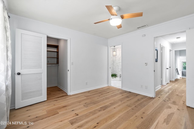 unfurnished bedroom with light hardwood / wood-style flooring, ceiling fan, and a closet