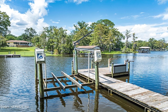 dock area with a water view and boat lift