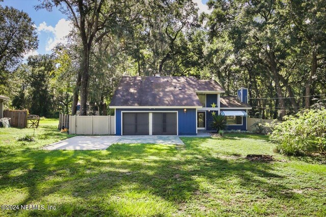 back of house with a yard and a patio area