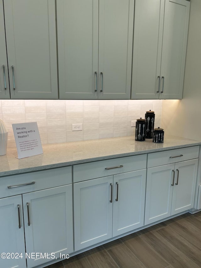 95246 Golden Glow Dr, Fernandina Beach, FL 32034 - kitchen with decorative backsplash, light stone countertops, and dark wood finished floors