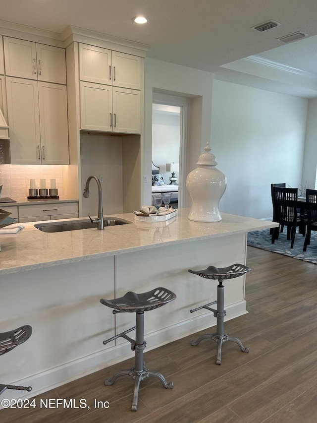 95246 Golden Glow Dr, Fernandina Beach, FL 32034 - kitchen with light stone counters, dark wood-style floors, a breakfast bar, and recessed lighting