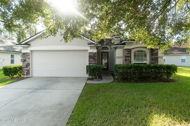 ranch-style house featuring a garage and a front lawn