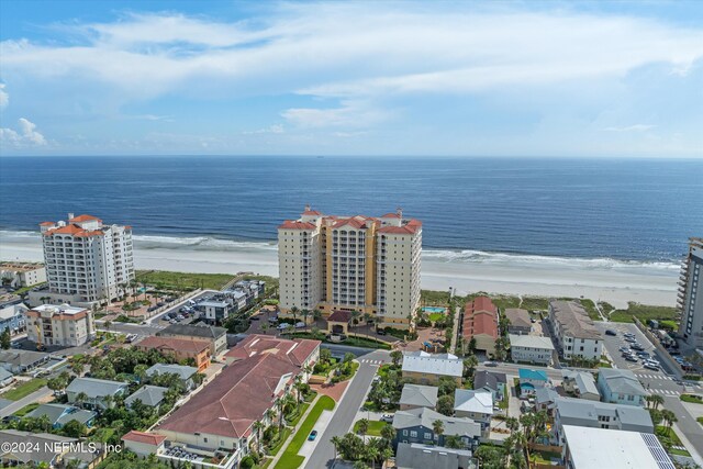 drone / aerial view featuring a water view and a beach view