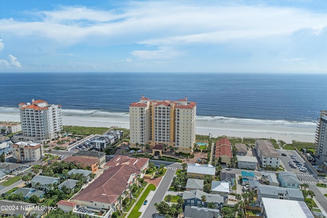 drone / aerial view with a water view and a beach view