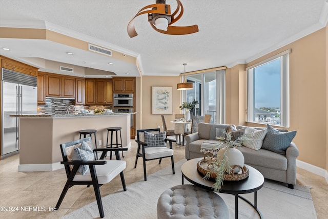 living area with visible vents, crown molding, and a textured ceiling