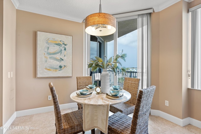 dining space with crown molding, tile patterned flooring, and baseboards