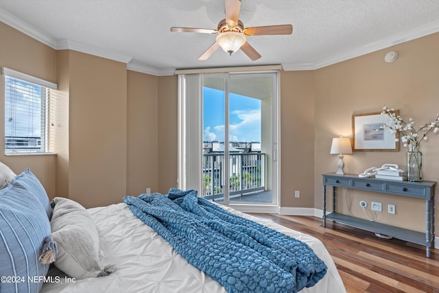 bedroom featuring baseboards, ornamental molding, wood finished floors, access to outside, and a textured ceiling