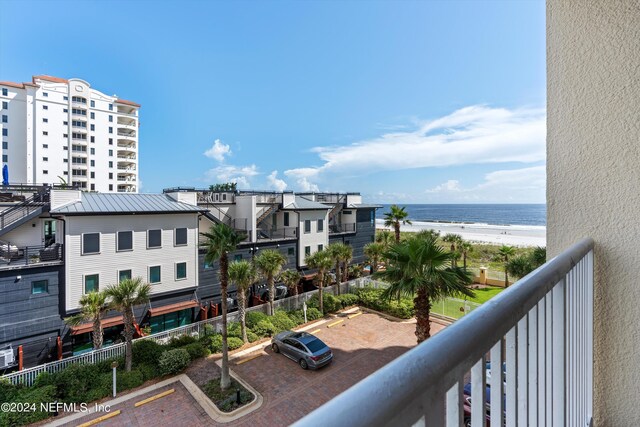 balcony featuring a water view and a view of the beach