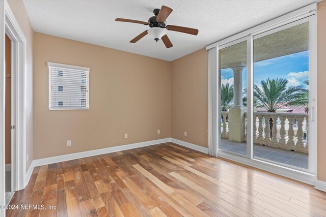 unfurnished room with a textured ceiling, ceiling fan, and wood-type flooring