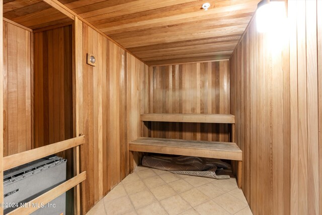 view of sauna / steam room with wooden ceiling and tile patterned flooring