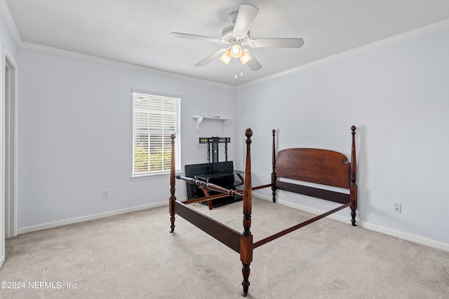 carpeted bedroom featuring crown molding and ceiling fan