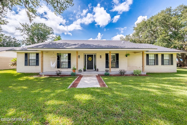 ranch-style house with a porch and a front lawn