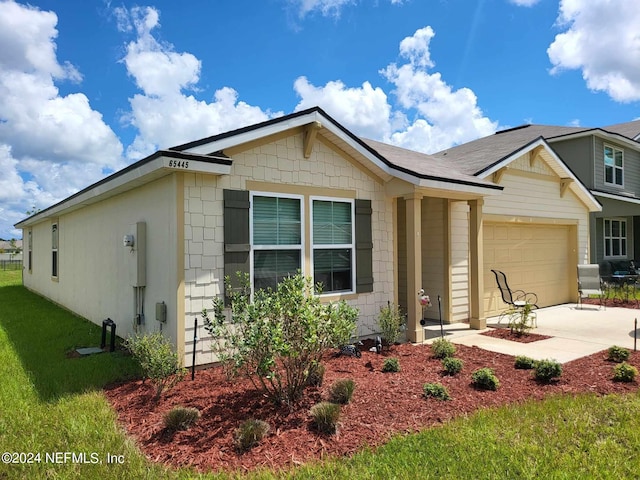 single story home with a front yard, driveway, and an attached garage