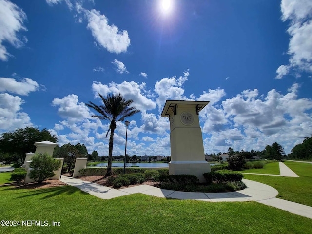 view of property's community featuring a water view and a yard