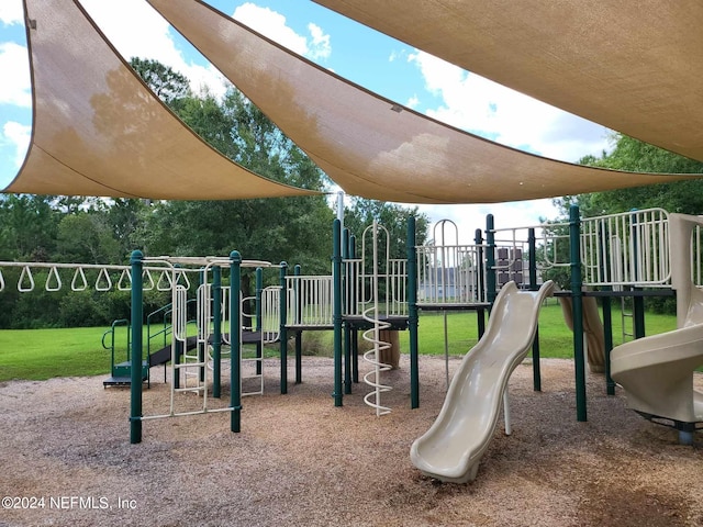 community jungle gym featuring a yard