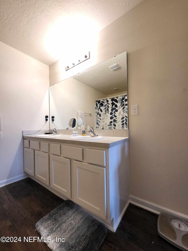 bathroom featuring vanity, a textured ceiling, and wood-type flooring