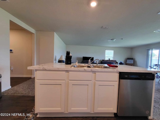 kitchen featuring light countertops, stainless steel dishwasher, and white cabinetry