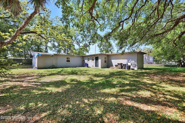 back of property with a yard