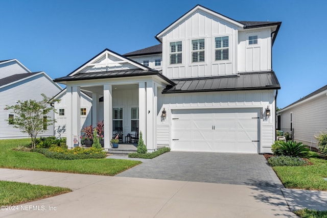 view of front facade with a porch and a garage