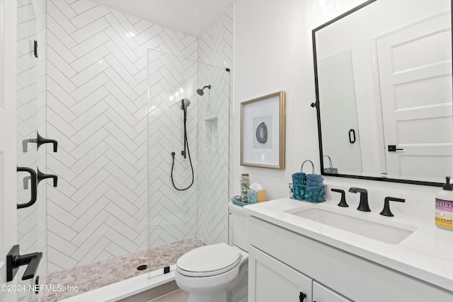 bathroom with vanity, toilet, and a shower with shower door