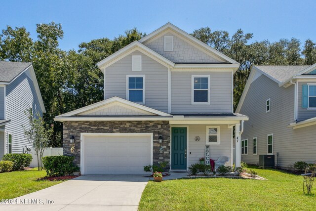 view of front of home featuring a garage, a front lawn, and central AC