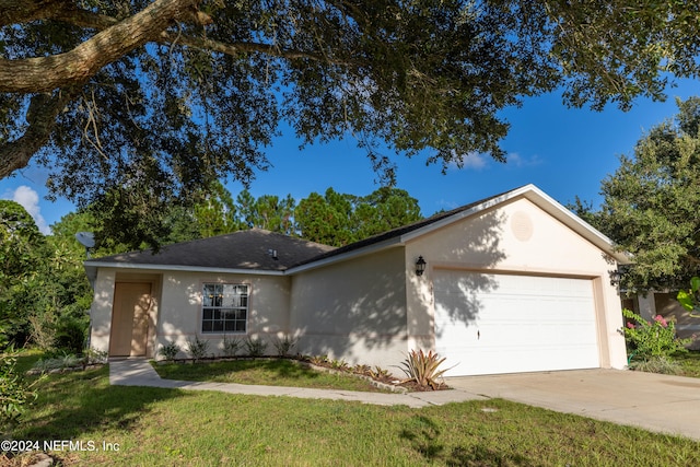 ranch-style home featuring a front yard and a garage