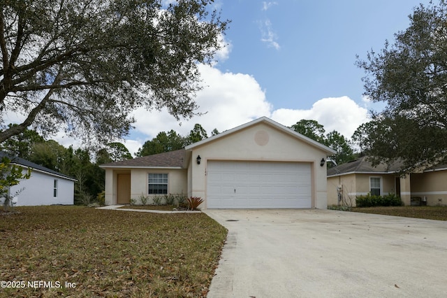 single story home with a garage, driveway, and stucco siding