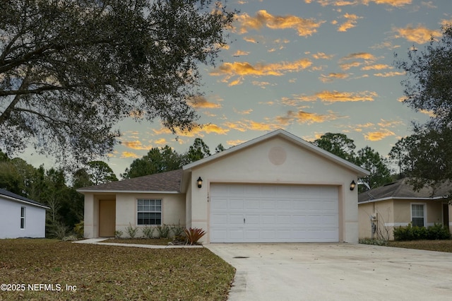 ranch-style home featuring an attached garage, a shingled roof, concrete driveway, and stucco siding