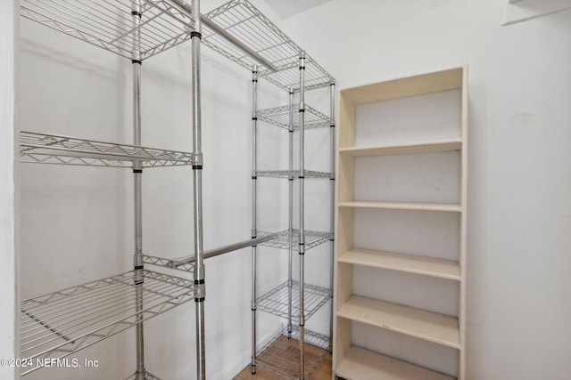 spacious closet with hardwood / wood-style floors