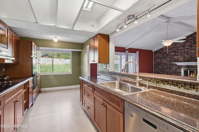 kitchen featuring vaulted ceiling with beams, stainless steel dishwasher, sink, and a wealth of natural light