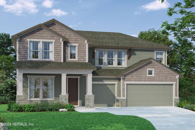 craftsman house featuring stone siding, a garage, concrete driveway, and a front yard