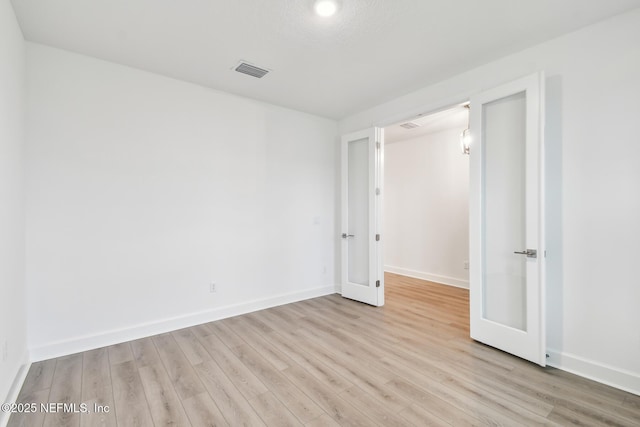 211 Rushing Dr, Saint Augustine, FL 32092 - unfurnished bedroom with light wood-style floors and french doors