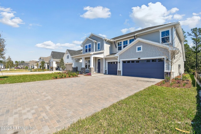 211 Rushing Dr, Saint Augustine, FL 32092 - craftsman-style house featuring decorative driveway, an attached garage, stone siding, and a front yard