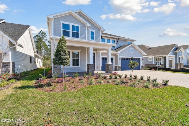 211 Rushing Dr, Saint Augustine, FL 32092 - craftsman-style home with covered porch, driveway, an attached garage, and a front lawn
