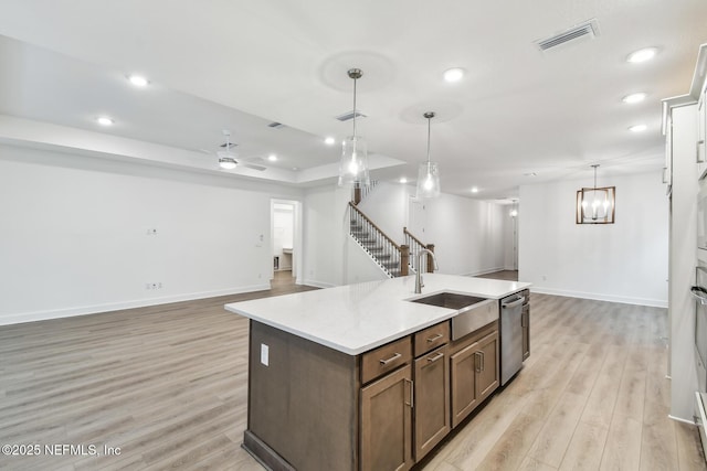 211 Rushing Dr, Saint Augustine, FL 32092 - kitchen with stainless steel dishwasher, open floor plan, light wood-type flooring, recessed lighting, and light countertops