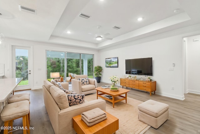 211 Rushing Dr, Saint Augustine, FL 32092 - living room featuring a tray ceiling, light wood-style floors, ceiling fan, and recessed lighting