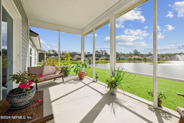 unfurnished sunroom featuring a water view