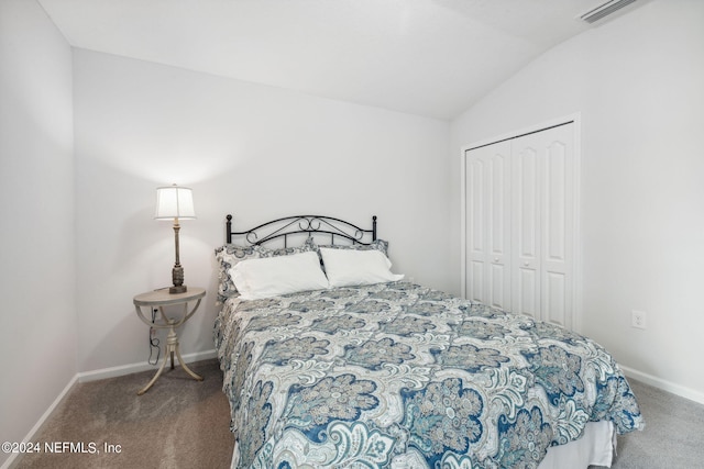 carpeted bedroom featuring vaulted ceiling and a closet