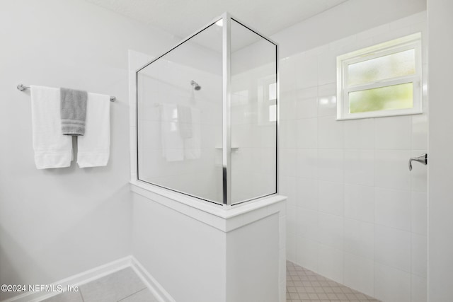 bathroom featuring a tile shower and tile patterned floors