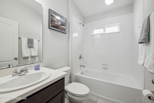 full bathroom featuring tile patterned flooring, toilet, tiled shower / bath combo, and vanity