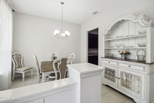 interior space featuring light tile patterned floors and a chandelier