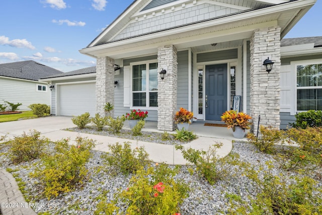 doorway to property featuring a garage and covered porch