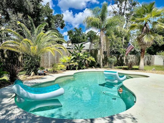 view of swimming pool with a patio area and a fenced backyard